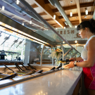 Melina Dimick, a clinical nutrition major, is preparing a plate of food at the Segundo Dining Commons. It’s part of a research project to help develop a new app that aims to encourage healthy eating habits. Photo by: Jael Mackendorf, UC Davis