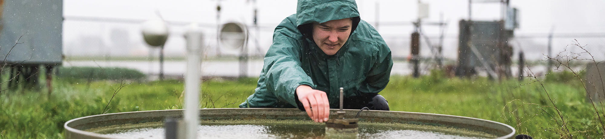 A student gathering data at the weather station.