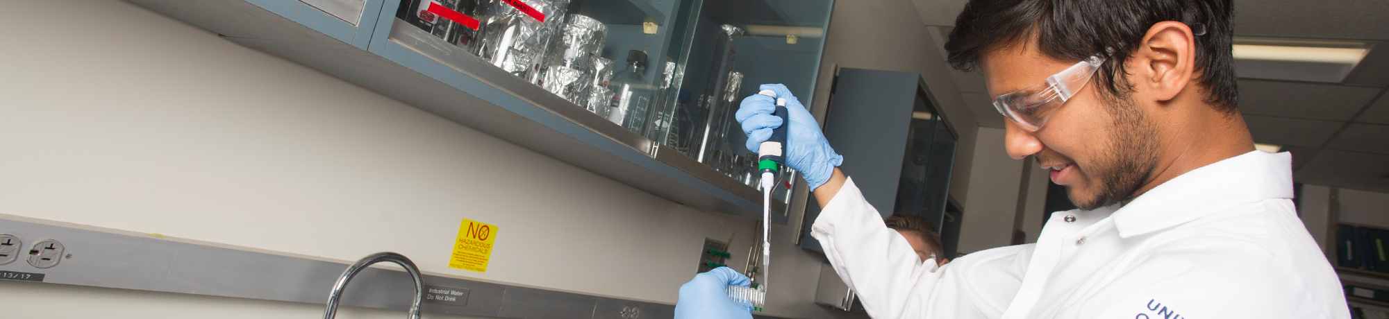 A person in a lab using scientific instruments.
