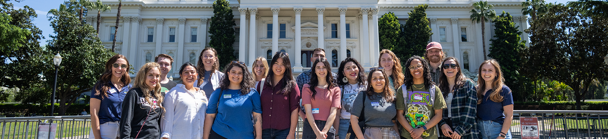 A group of people outside the California capitol during a tour.