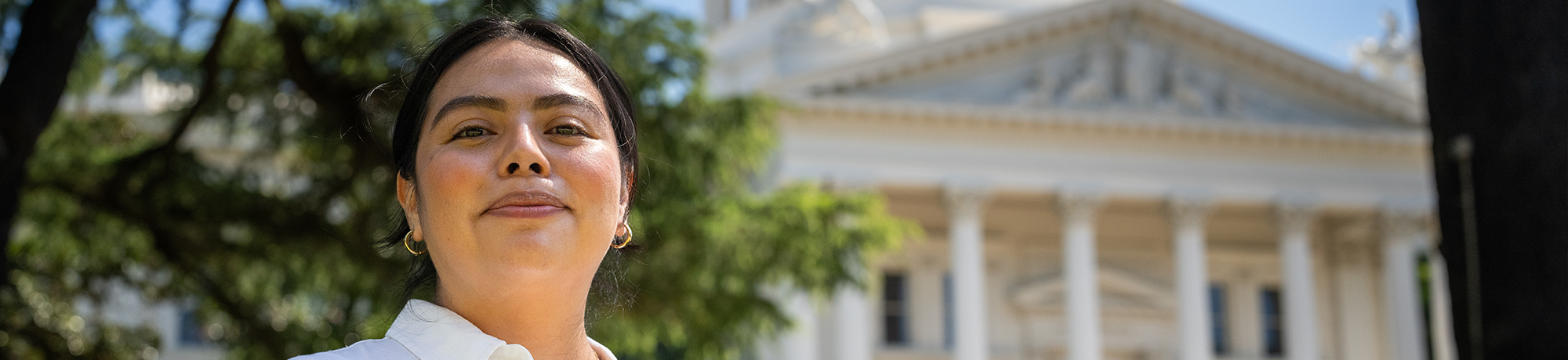 A person standing in front of the state capitol.