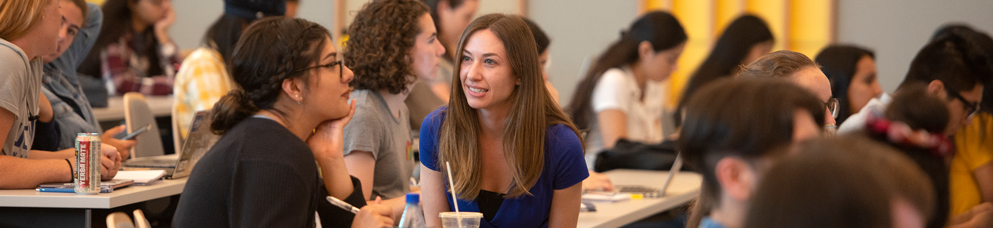 Lecturer Debbie Fetter talks with a student about her diet results during Nutrition 10 in California Hall.