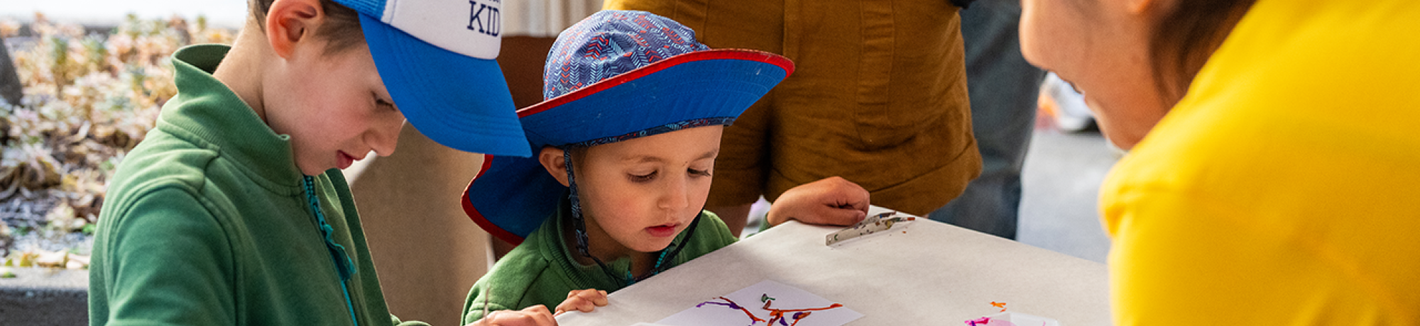 Children create beautiful art with the help of some colorful maggots at this 2025 Picnic Day event. (Jael Mackendorf/UC Davis)