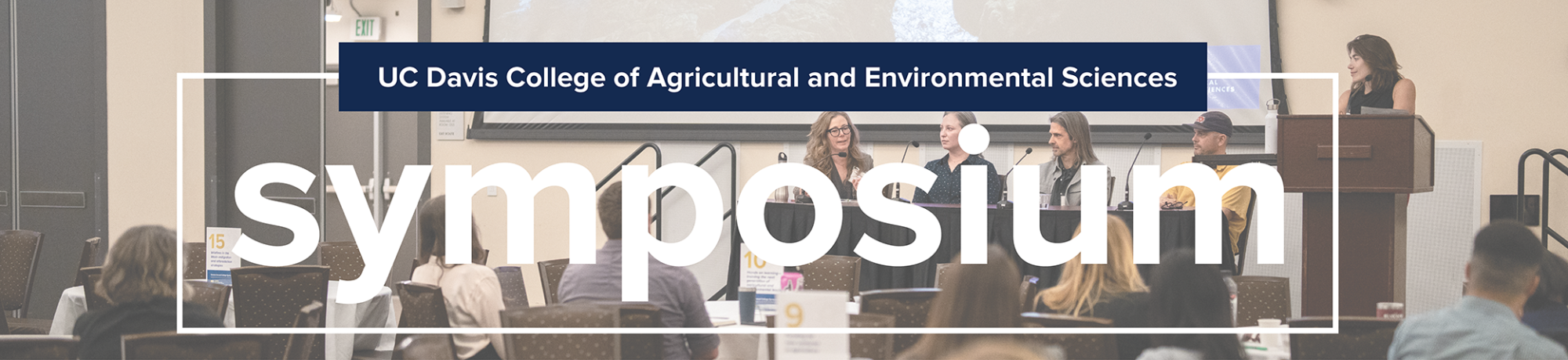Text reads "UC Davis College of Agricultural and Environmental Sciences Symposium" with a photo of four people sitting at a desk on a stage and one person standing beside them at a podium.